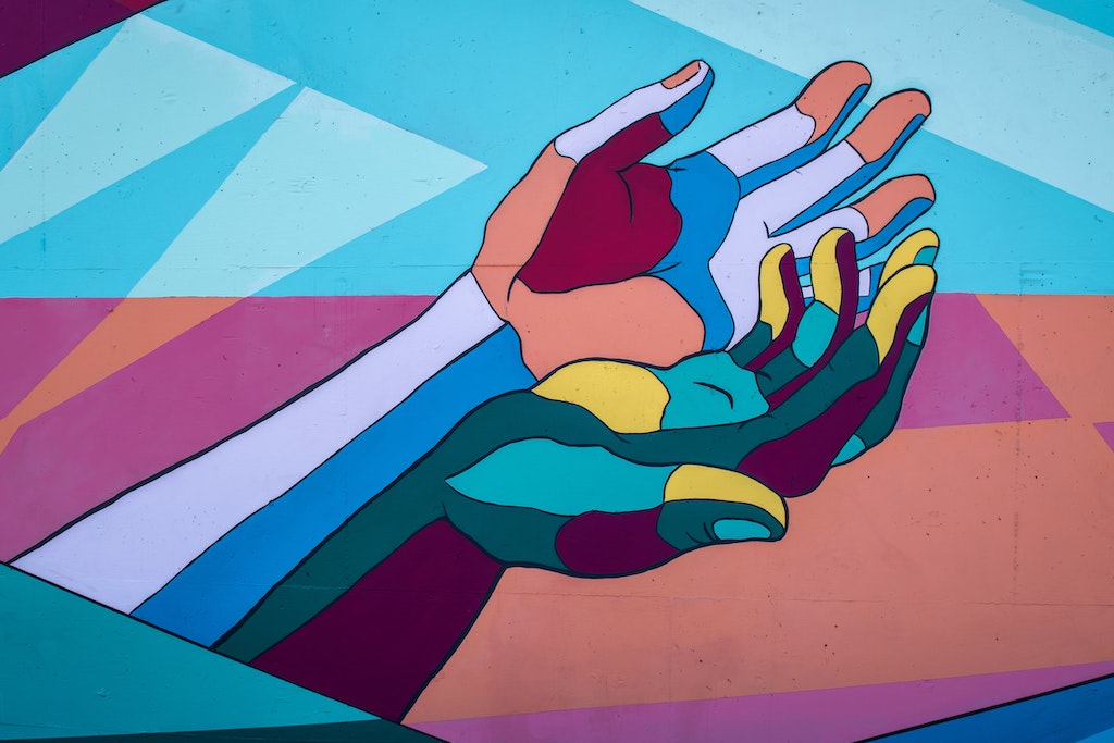 Graphic of colorful hands held together