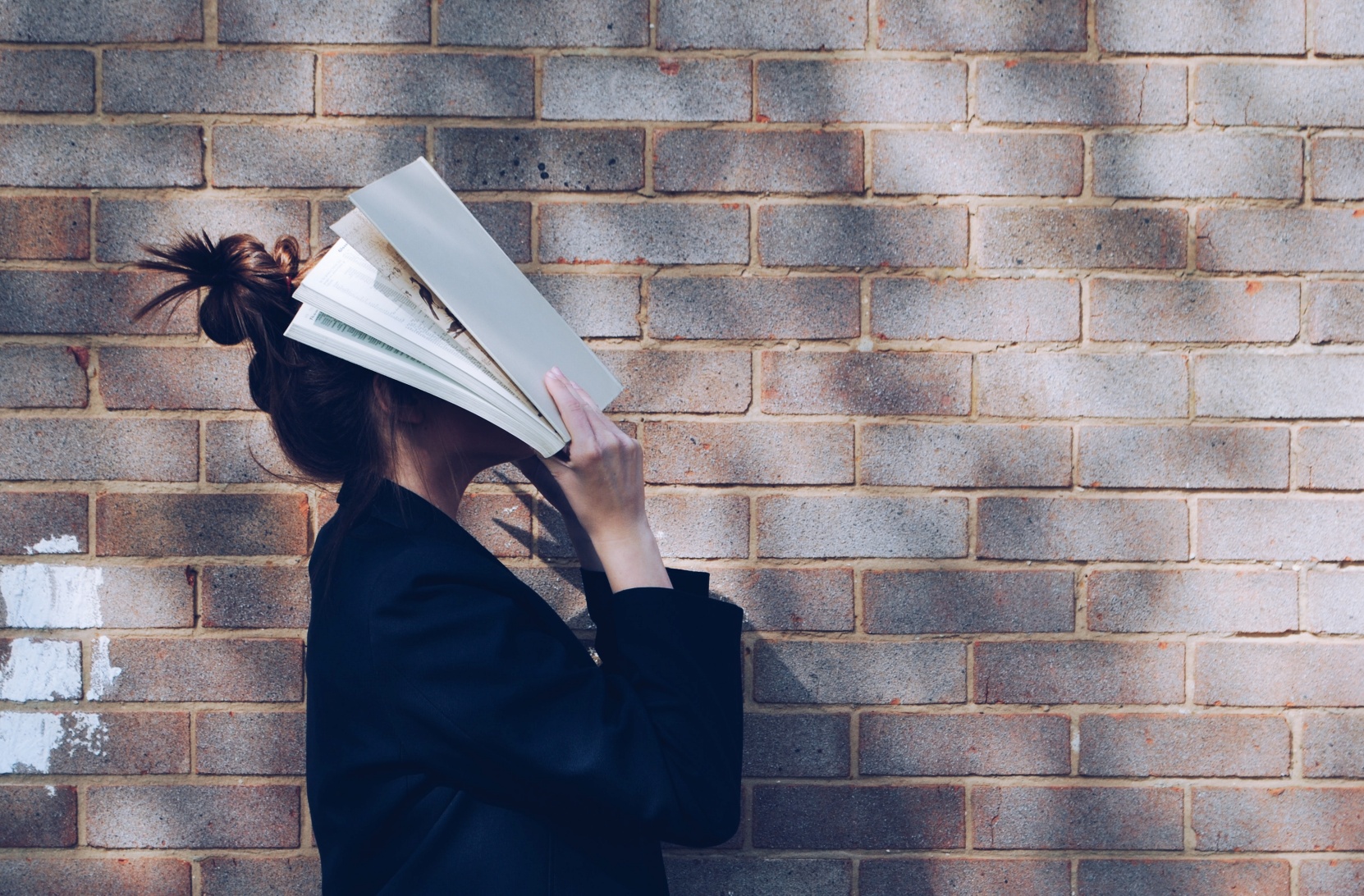 Women with paper pages over her page image